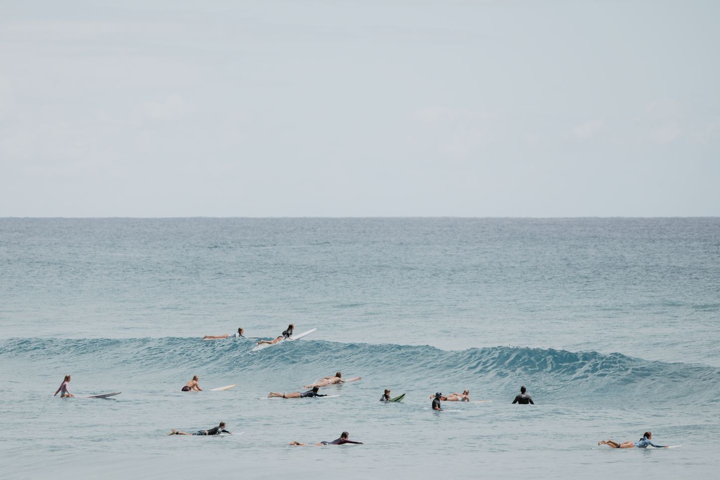 Australian Prints by Mackenzie Sweetnam. A group of surfers wait for the perfect wave in Queensland, Australia
