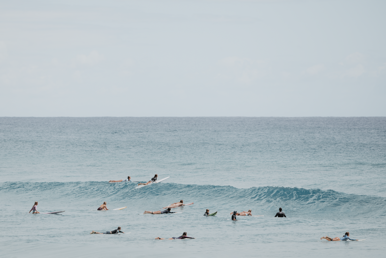 Australian Prints by Mackenzie Sweetnam. A group of surfers wait for the perfect wave in Queensland, Australia