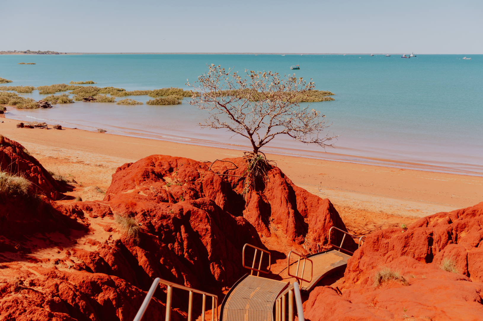 Australian Prints by Mackenzie Sweetnam. A photographic print of a Broome Staircase featuring strong orange and blue colours.